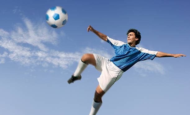 Football player kicking a ball